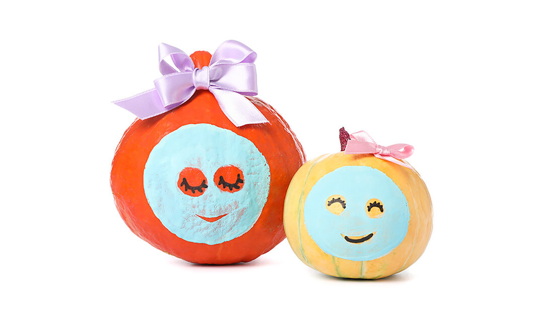 pumpkin facials - two pumpkins with facial skincare masks