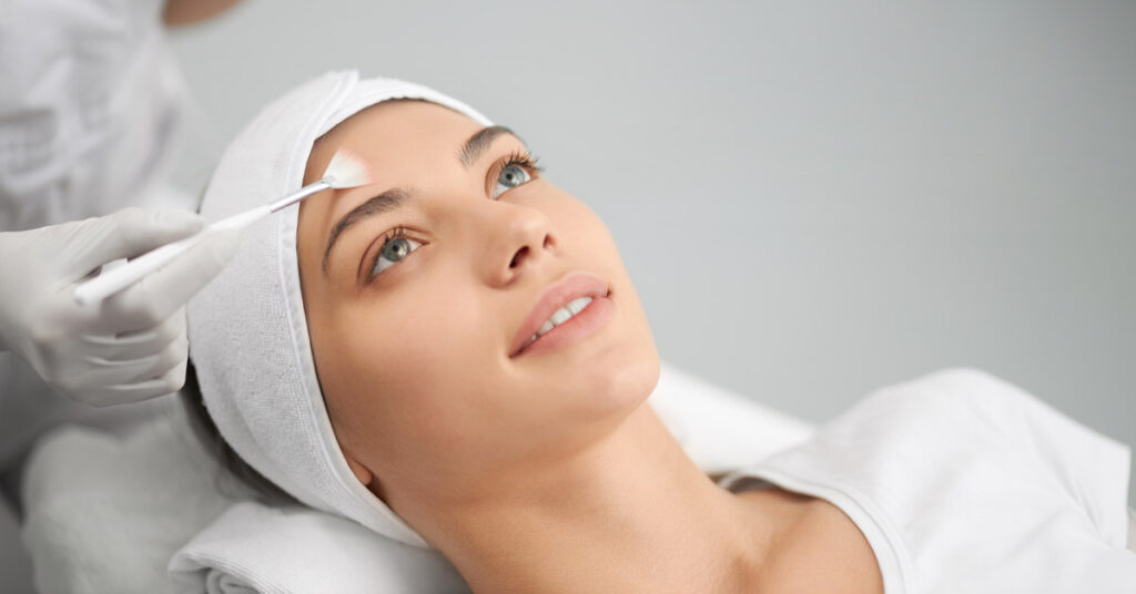 woman receiving a brightening peel skincare treatment