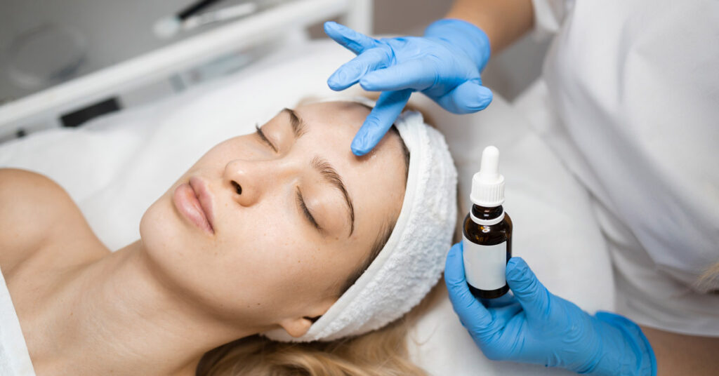 woman receiving a vitamin C serum treatment